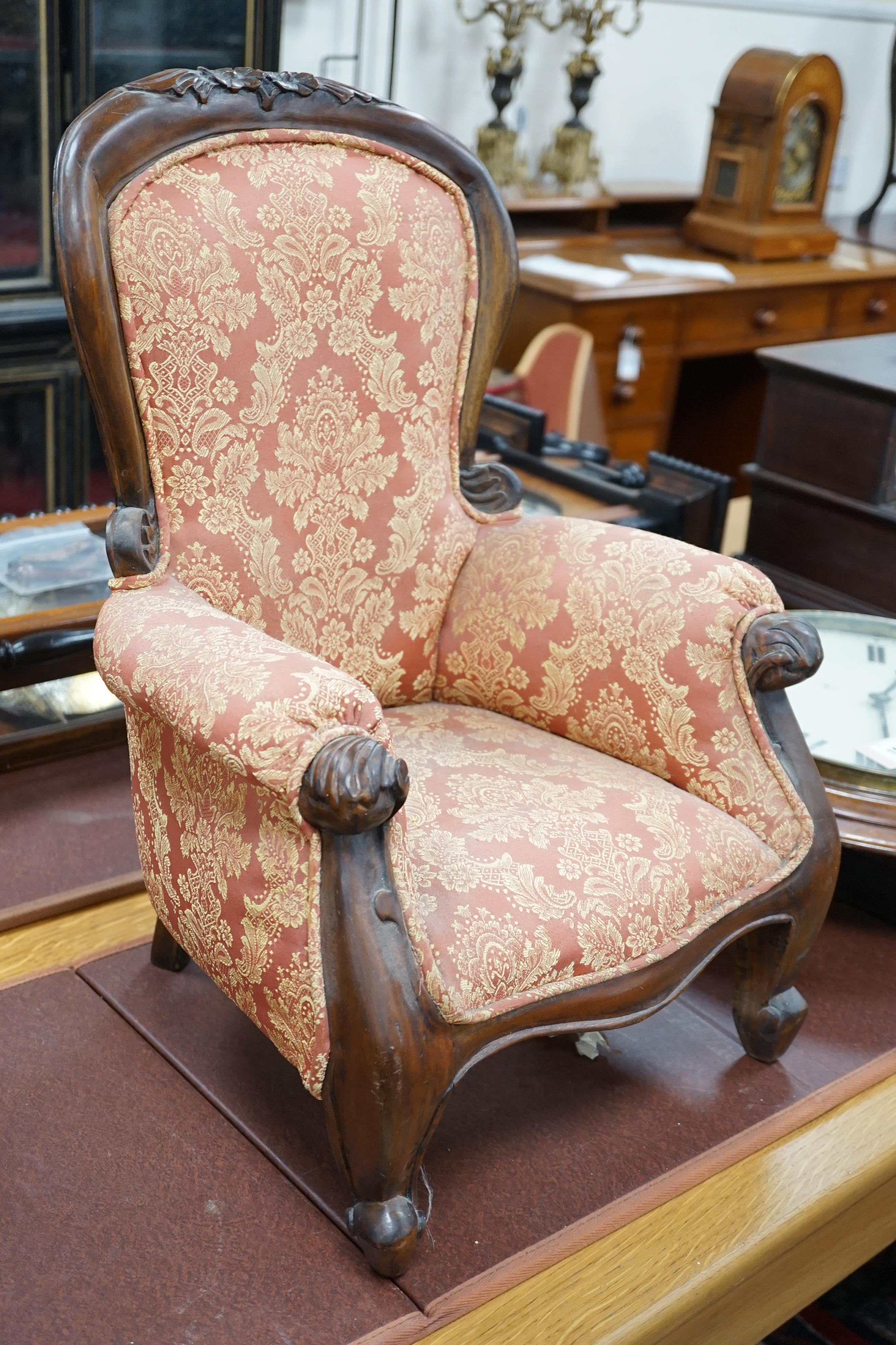 A Victorian style mahogany miniature upholstered elbow armchair, height 52cm